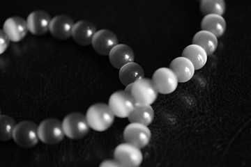 Stone necklace on a dark background close up. Black and white