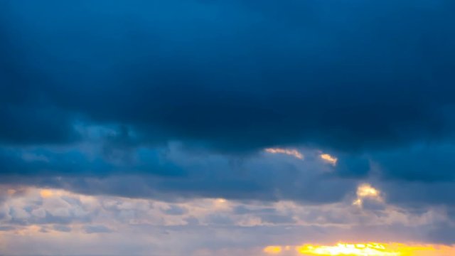 Dark and dramatic storm cloud area background. Time Lapse. Epic storm tropical clouds at sunset. Coast of the Pacific Ocean. Palm beach. Timelapse 4K UHD.