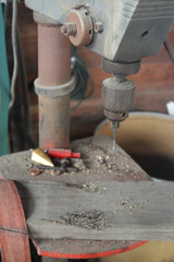 Drill Press in workshop with old tools