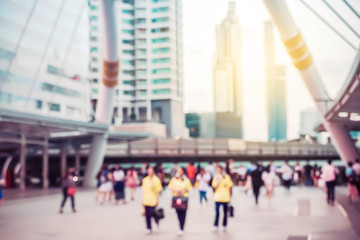 Blurred background. Blurred people walking through a city street on sunset of an urban landscape