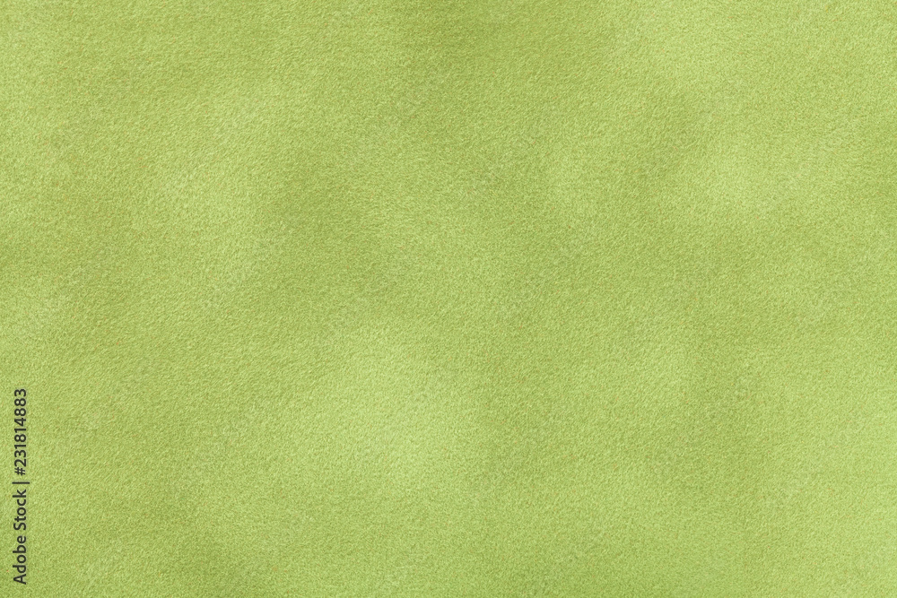 Wall mural light green matt suede fabric closeup. velvet texture.