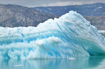 Icebergs are huge mountains of ice, a breakaway from a glacier and drifting in the sea or ocean.