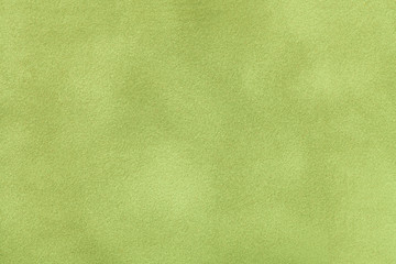 Light green matt suede fabric closeup. Velvet texture.