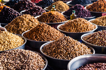 A mixture of nuts on the market. Various nuts in the store, juicy snacks sold in the market. Food for vegetarians. Ingredient for cooking and sweets. 