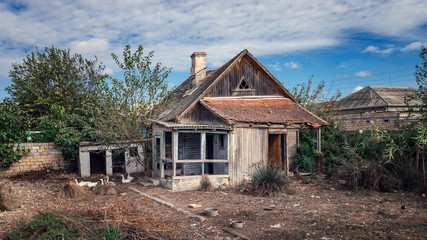 Fototapeta na wymiar Old abandoned wooden rural house and yard