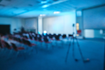 conference lecture theatre cinema hall or seminar room background with projection light theatre blur