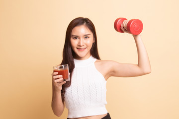 Healthy Asian woman with dumbbell and  tomato juice.