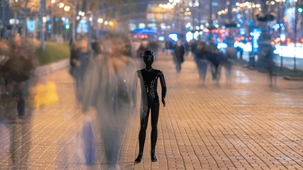 The dummy standing on the evening street with people
