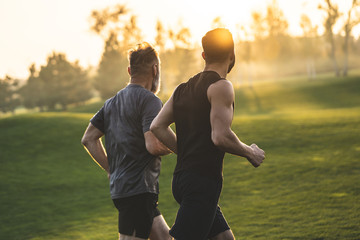 The two sportsmen running on the grass