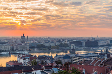Fototapeta na wymiar Fisherman's Bastion is an important landmark of Budapest. View of the city from a height, panorama at sunrise. Monument of historical architecture. The Danube River is far away. Morning in the fog. Wh