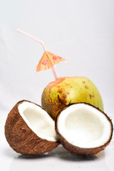 Broken coconut and green coconut isolated on white background
