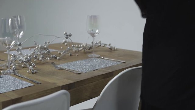 Preparing Christmas table with decoration, fork and knife on the white backround.