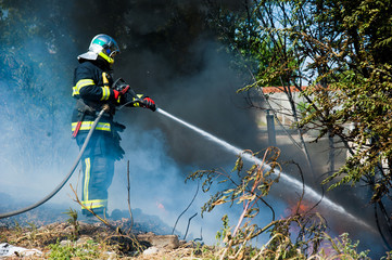 Firefighter extinguishes a fire