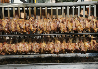 many pieces of meat cooked on a spit