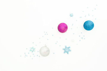 New Year composition with balls and pink confetti on white background. Flat lay, top view