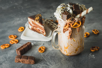 Chocolate shake with milk, dripping sauce, cream, cake and cookie