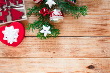 Obraz na płótnie Canvas Christmas decorations and gifts on the wooden background. Fir-tree with red ornaments. 
