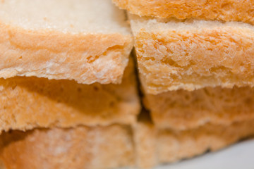 Background crust bread. Fragrant baking. Soft and fresh piece of bread.