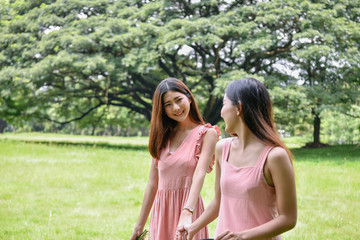 Naklejka premium Holiday concept. Beautiful girl is getting flowers. Beautiful girl enjoys the scenery and nature.