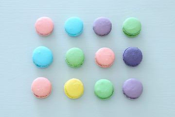 Fototapeta na wymiar Top view of colorful macaron or macaroon over pastel blue background. Flat lay.