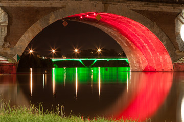 Toulouse, France, May 2010, Pont Neuf in Toulouse colorfully lit at night, the color is changing...