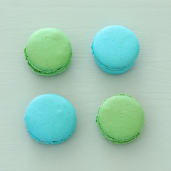 Top view of colorful macaron or macaroon over pastel blue background. Flat lay.