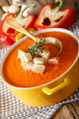 Traditional sweet pepper puree soup with croutons close-up. Vertical