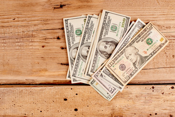 American dollars on wooden background close-up with copy space. Business and Finance..