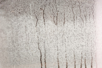 Misted glass close up. Water flows over the glass.