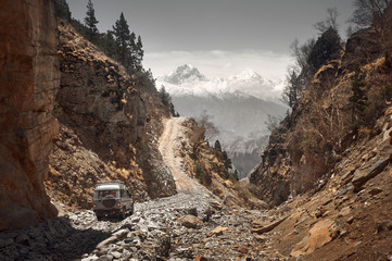 Off-road vehicle goes an extreme mountain path during an expedition to Himalayas - 231825898