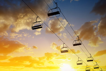 Silhouette the cableway at colorful sunset sky.