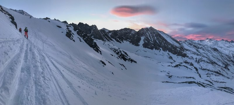 ski hiking and climbing in apline mountains in winter