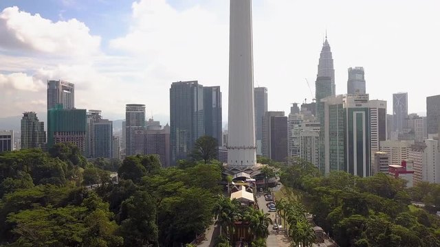 Raising up from the gardens at the base of the enormus well iconic Menara Tower in Kuala Lumpur KL Malaysia