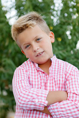 Happy child with pink shirt in the garden