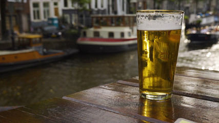 Close up of a beer by the side of an Amsterdam canal.