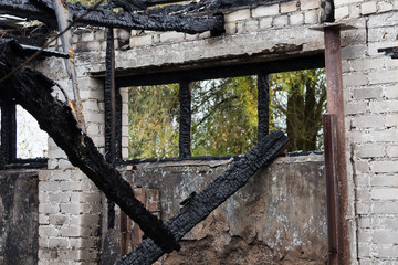 the ruins of a fully burned farm in Latvia on October