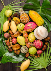 Assorted Thai tropical fruits on a dark wooden rustic background.