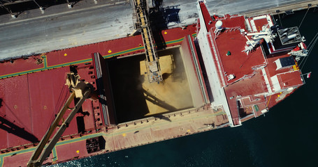 Drone shot of ship loading bulk grain in Australian port.