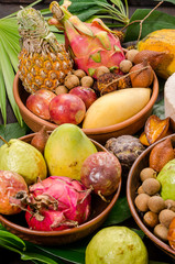 Assorted Thai tropical fruits on a dark wooden rustic background.