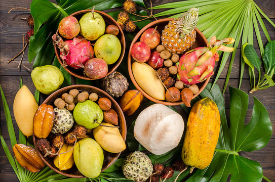 Assorted Thai tropical fruits on a dark wooden rustic background.