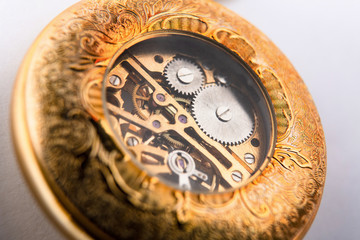 the inside of a classic watch gear wheels of a pocket watch