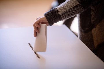Person voting, casting a ballot