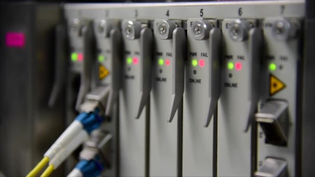 Networking Temecommunication fiber optics cable patch cord connected and blinking of led status in data center