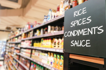 Rice, spices, condiments, sauces grocery categoy aisle at supermarket