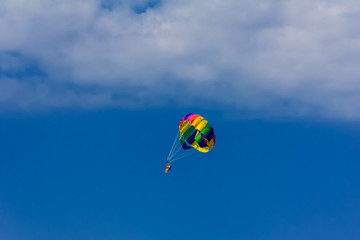 vacationers fly on a parachute on a summer holiday by the sea in the resort