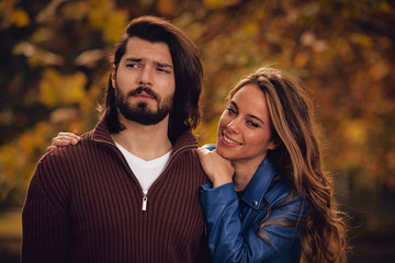Couple in autumn season colored park enjoying outdoors.