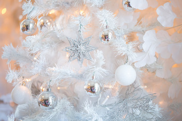 Fototapeta na wymiar Christmas background in white with white Christmas tree. closeup shot. blurred background