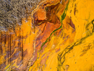 Aerial shot of pollution by toxic waste flowed to the surface and destroys forests and lakes