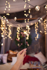 Night background with a star christmas sparkler. Sparkler Bokeh Colorful sparkler. Shallow focus