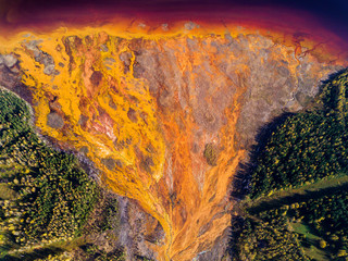 Aerial shot of pollution by toxic waste flowed to the surface and destroys forests and lakes